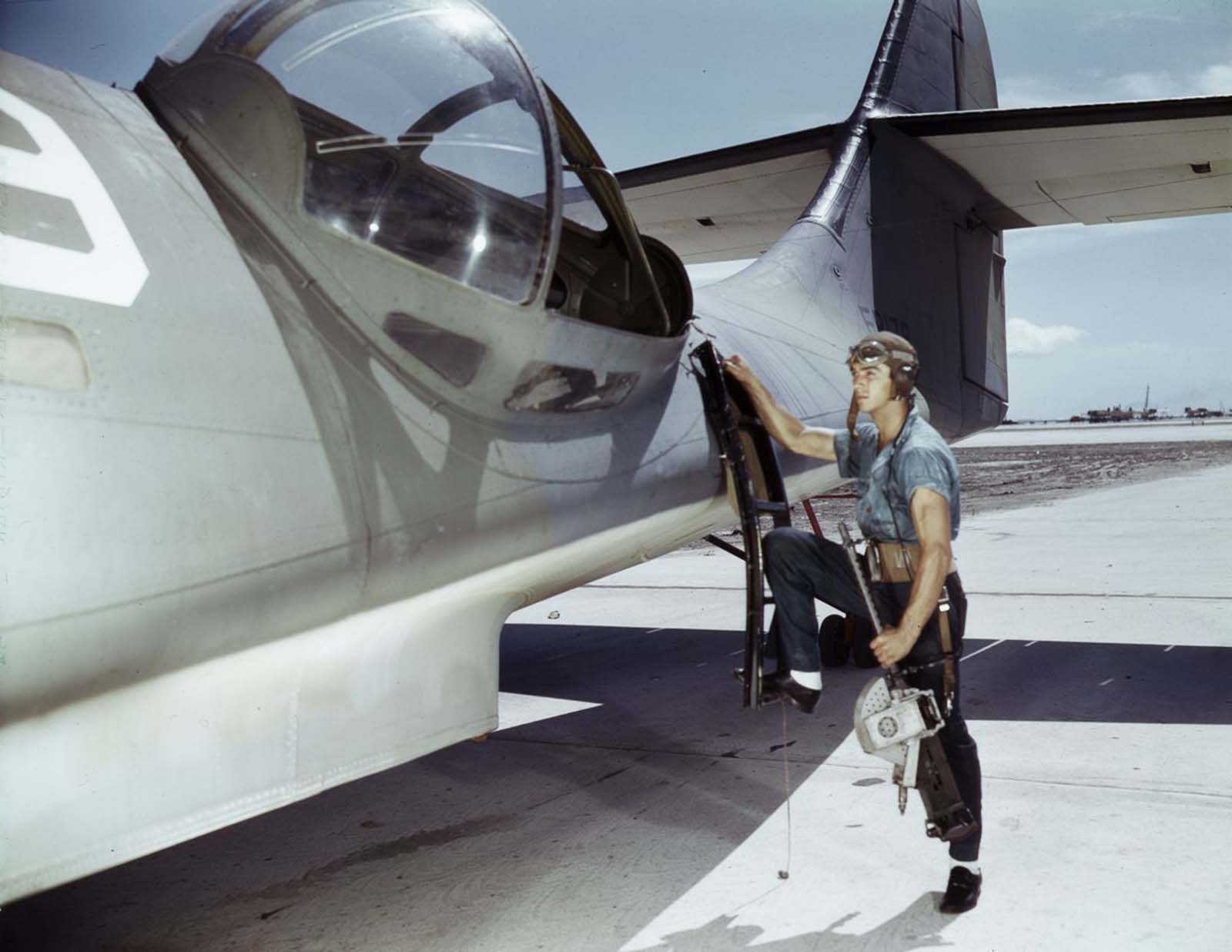 Aviation Ordnance Mate Jesse Rhodes Waller prepares to install a .30-caliber machine gun in a Navy PBY plane.