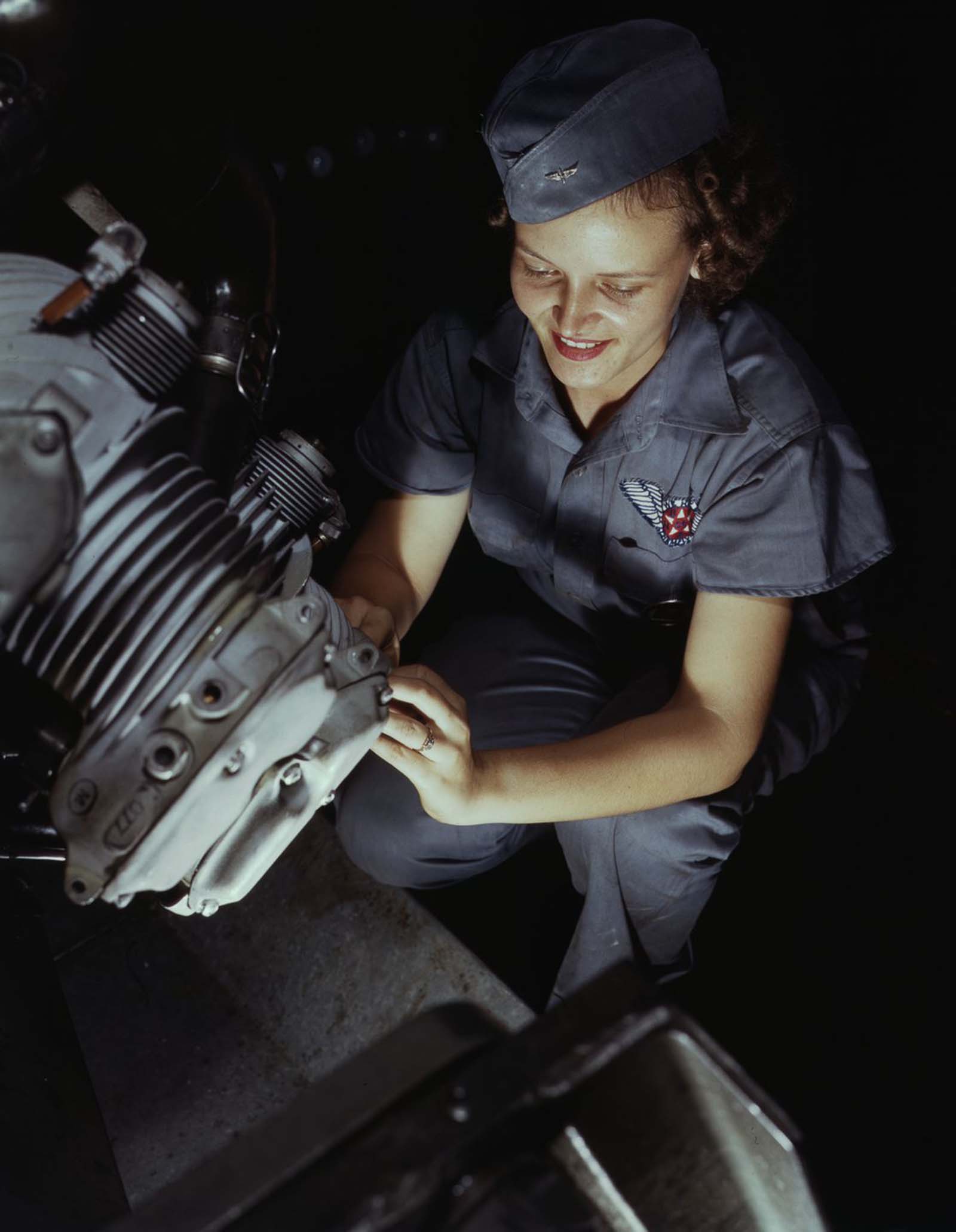 Assembly and Repairs Dept. mechanic Mary Josephine Farley works on a Wright Whirlwind motor.