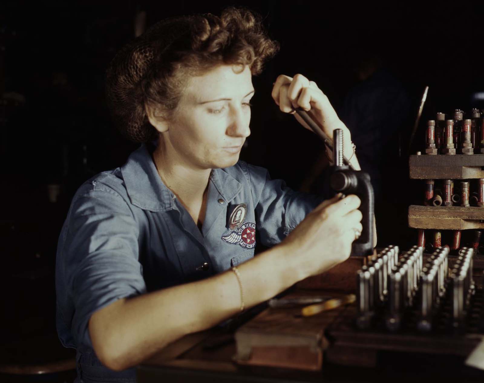 Doris Duke works on reconditioning spark plugs in the Assembly and Repair Department.