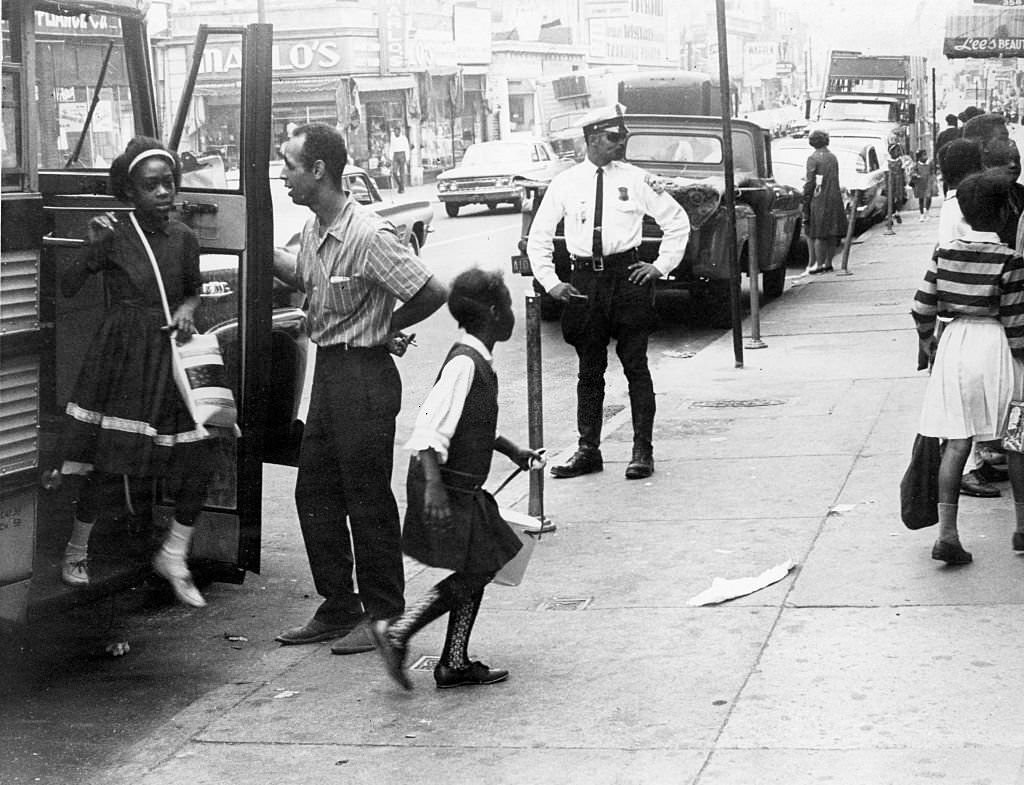 Students get off the bus from a suburban school at the end of the school day in Boston, 1965.
