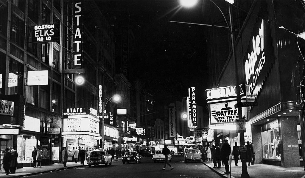 Pedestrians and cars make their way down Boston's Washington Street the night, 1965.