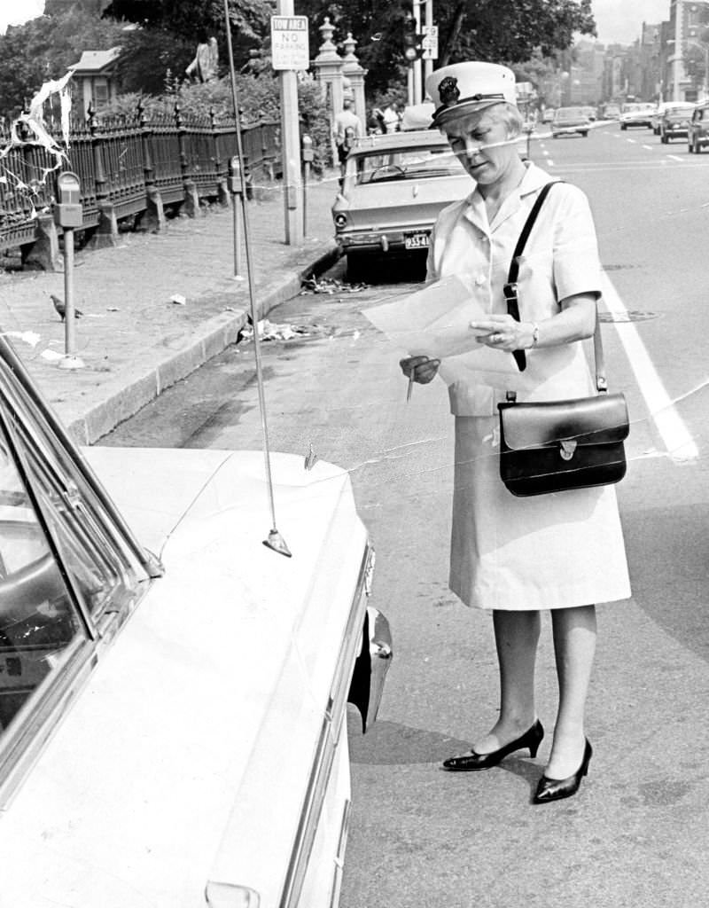 Meter maid Mary Martin makes her rounds in Boston on Jul. 7, 1966.