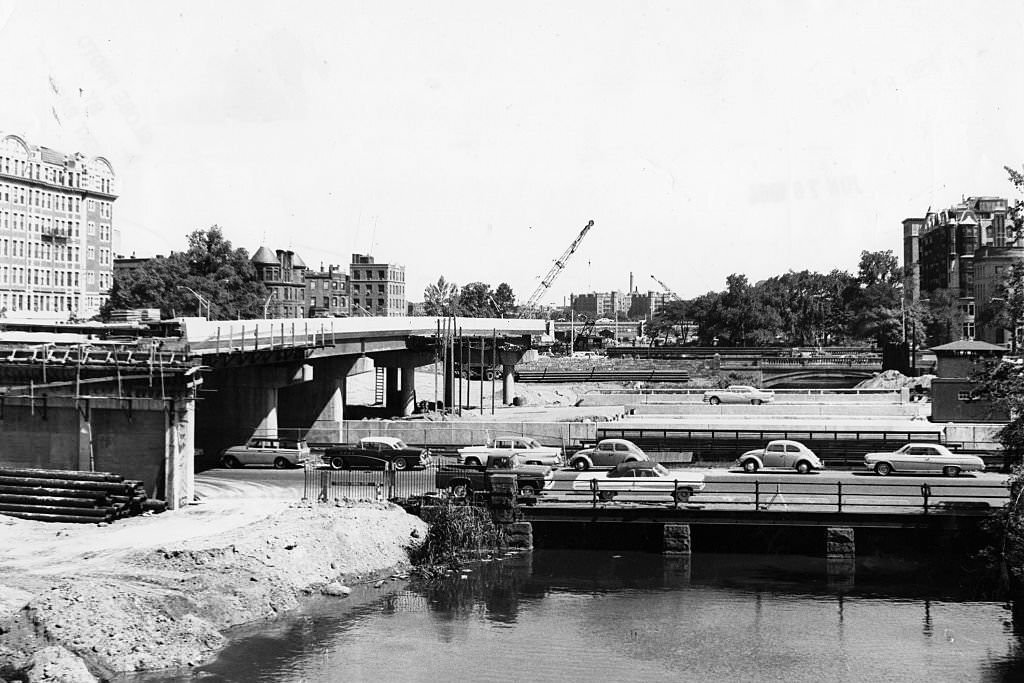 Construction continues on the toll road between Charlesgate East and West in Boston, blocking in part of the Muddy River, on June 15, 1964.