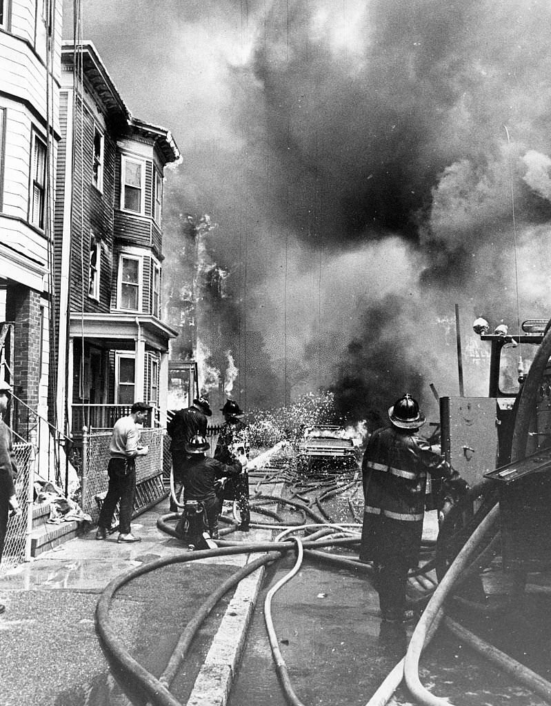 Firefighters battle a large fire on Bellflower Street in Dorchester in Boston on May 22, 1964.