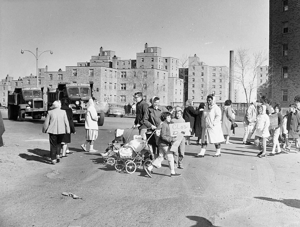 A group of residents from Columbia Point housing project in Boston picket to have the the nearby city and Mile Road Corp.