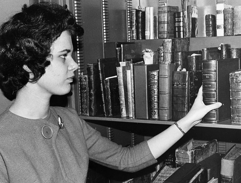 Janice Maniscalco, of the Boston Public Library's rare books department, reaches for a book in the library's rare book vault on Oct. 16, 1962.