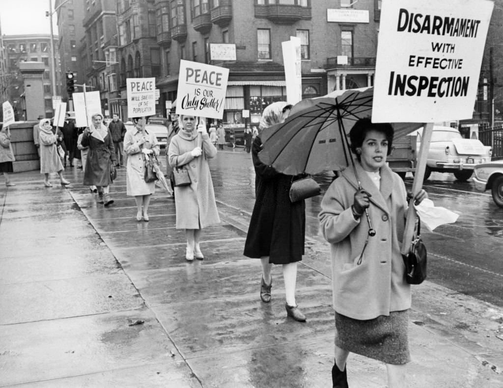Picketing women march in front of the Massachusetts State House as part of an international demonstration, "Women's Strike for Peace," in Boston, Jan. 15, 1962.
