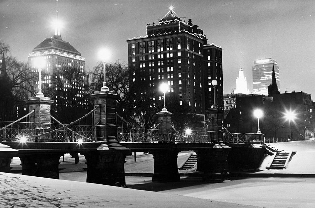 Snow covers the Public Garden in Boston at night on Dec. 1,1966. The Berkeley Building and Prudential Tower can be seen in the background.