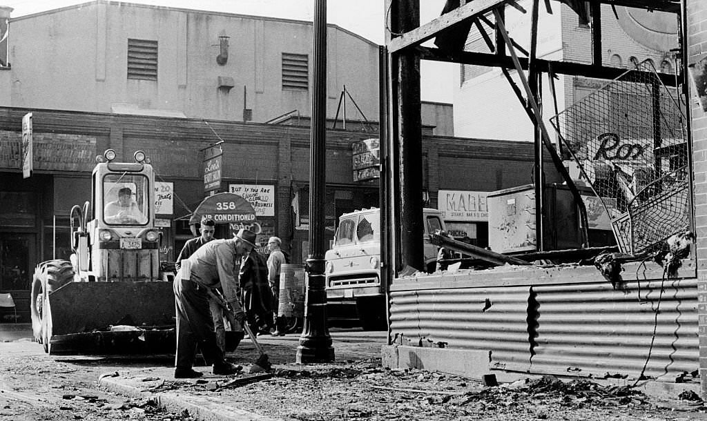 Workers clean up Blue Hill Avenue after riots on the street in the Roxbury neighborhood in Boston, June 1967.