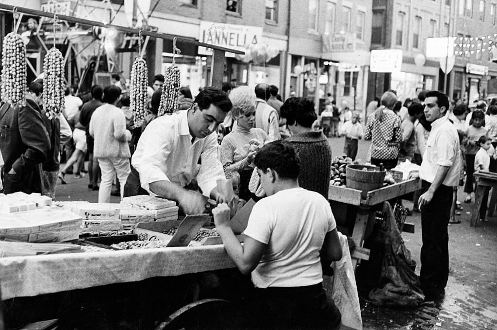 A vendor sells a boy peanuts at the Hanover Street Market in Boston's North End on Aug. 11, 1967.
