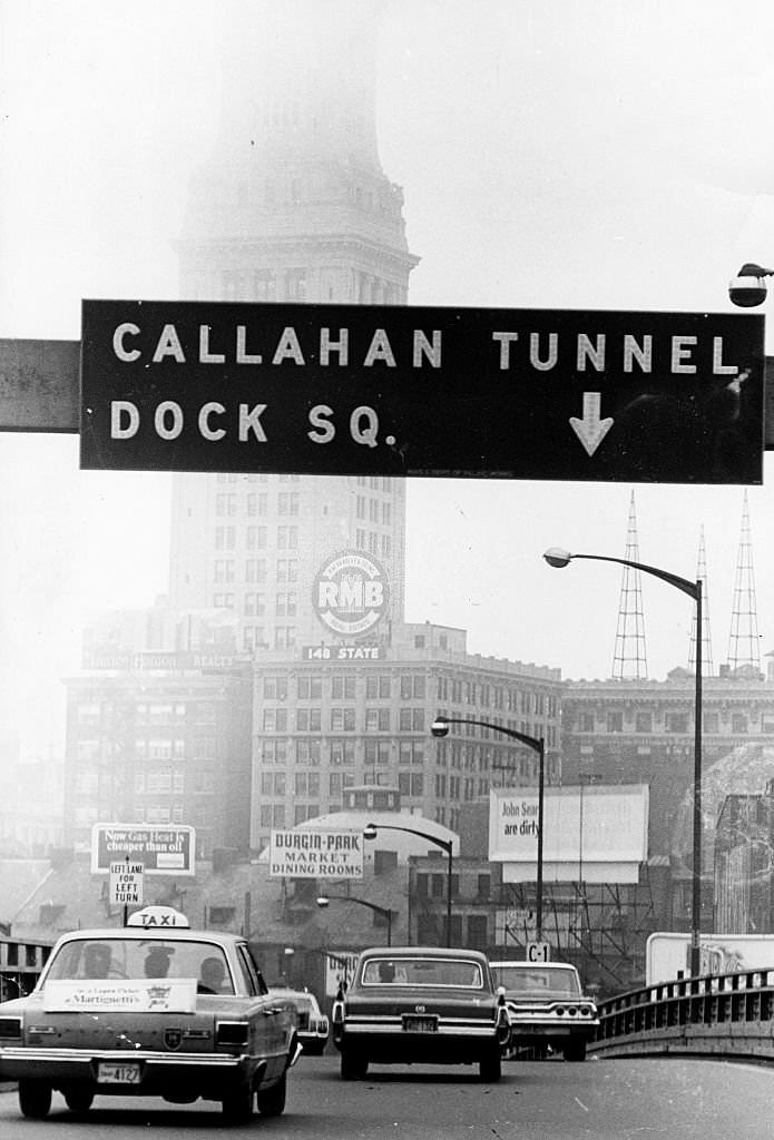 Cars exit the Southeast Expressway for the Callahan Tunnel in Boston on Oct. 10, 1967. The Custom House rises into the mist above the road.