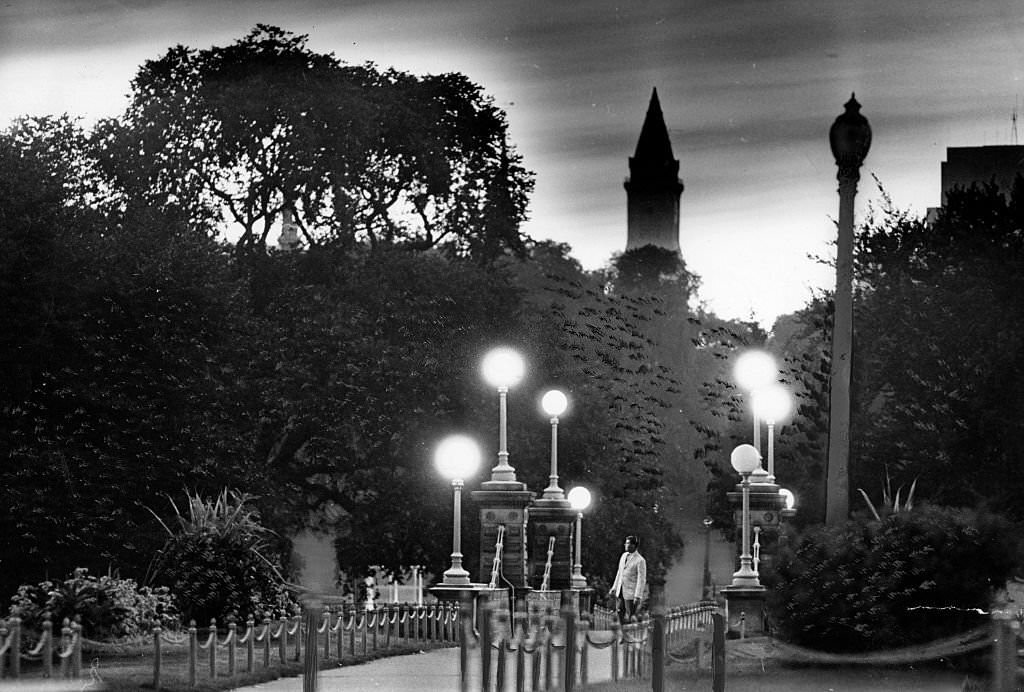 A man on a walk watches dawn from a bridge at the Public Garden in Boston, September 1962.