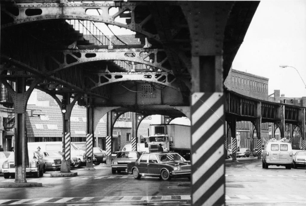 Cars drive under the MBTA Orange Line elevated tracks on Washington Street in Boston on March 11, 1986.