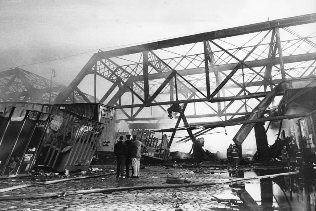 Firefighters work to extinguish a five-alarm fire on the Summer Street Bridge in Boston, May 15, 1968.