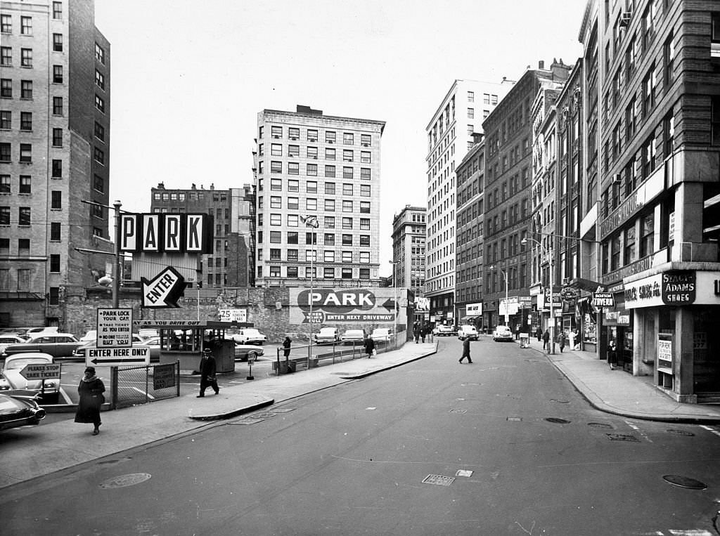 Pedestrians walk around the former "Newspaper Row" on Boston's Washington Street on Nov. 29, 1961.