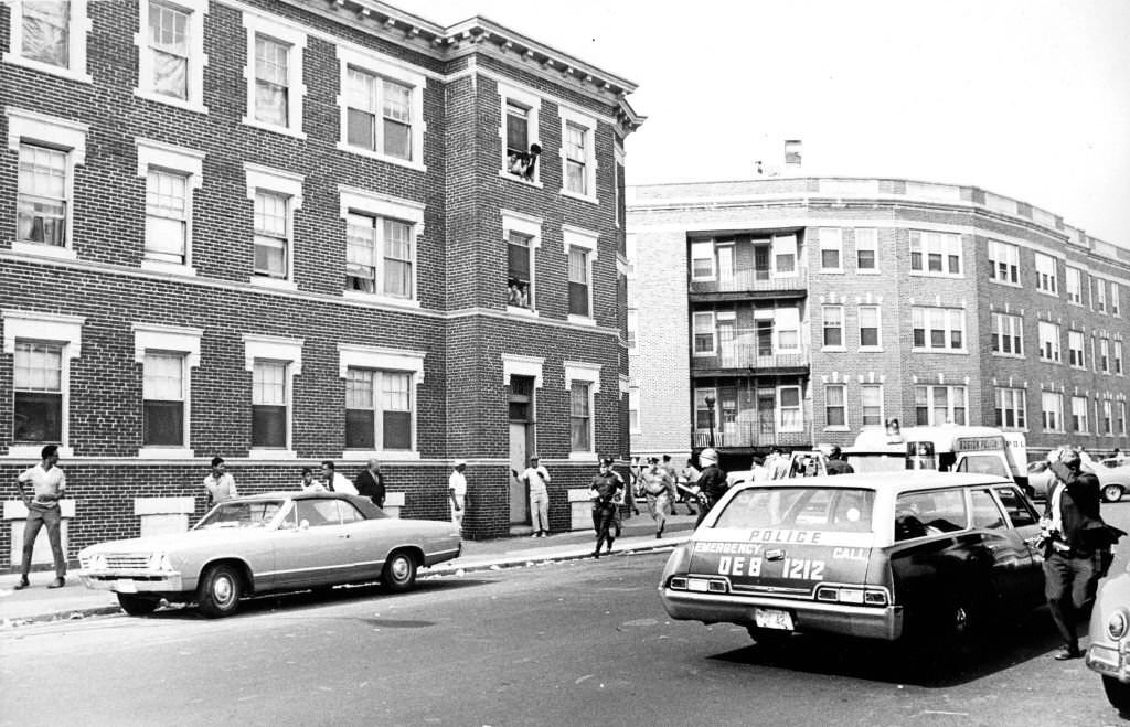 Boston Police officers race toward a disturbance near the Jeremiah Burke High School on Washington Street in the Dorchester neighborhood of Boston on Sep. 25, 1968.