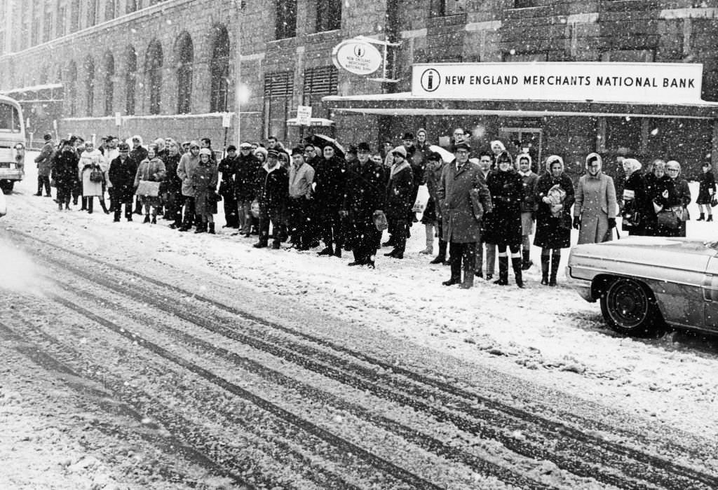 Commuters wait in the snow outside South Station in Boston on March 2, 1969.