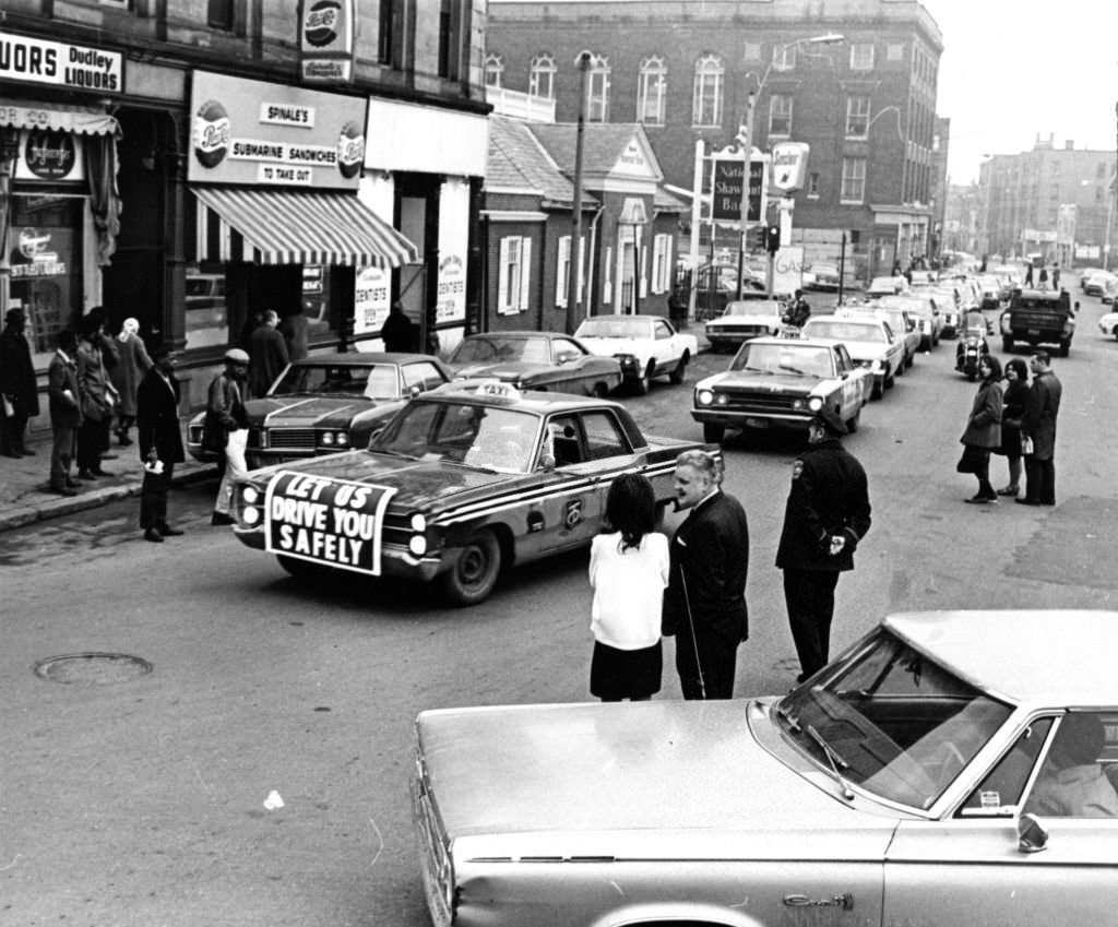 A motorcade of taxi cabs proceeds through Boston as about 200 Boston taxi drivers stages a tribute to a slain fellow driver on March 20, 1969.