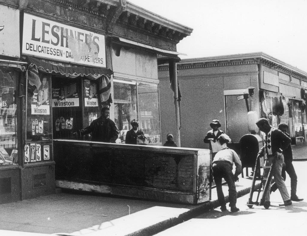 Workers move a new counter into a store called Leshners Delicatessen on Blue Hill Avenue in Boston on May 4, 1969.