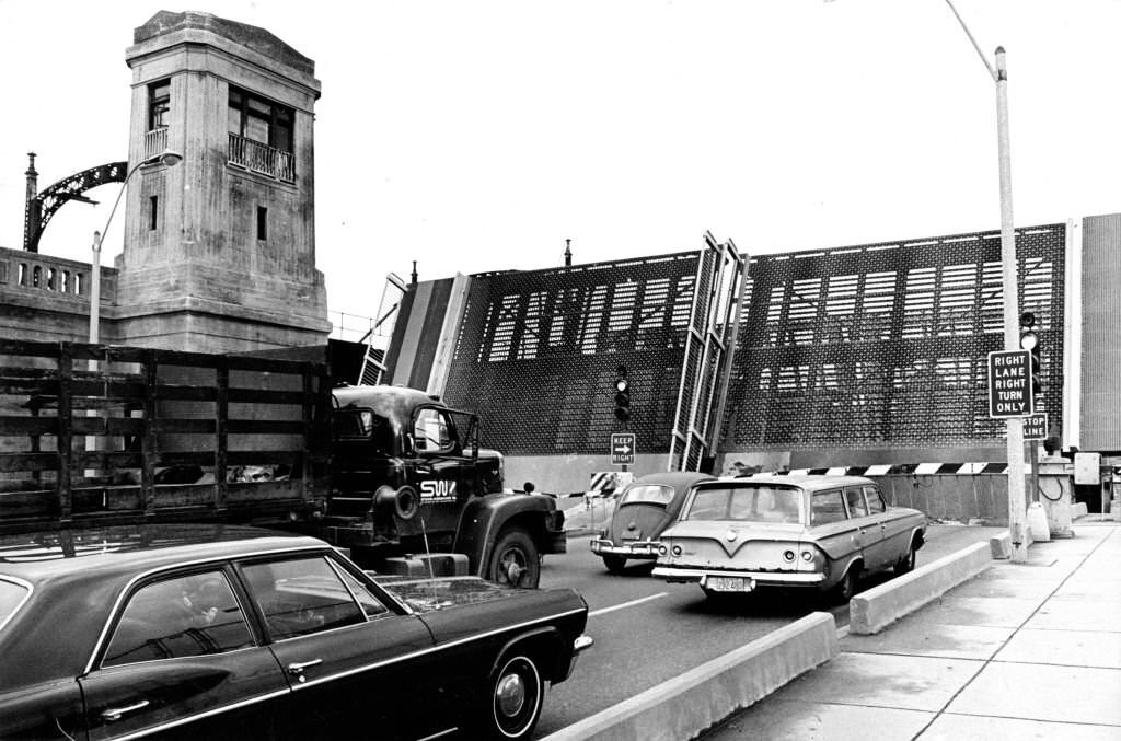 Vehicles pause as the Northern Artery drawbridge in Boston is raised on Dec. 10, 1969.