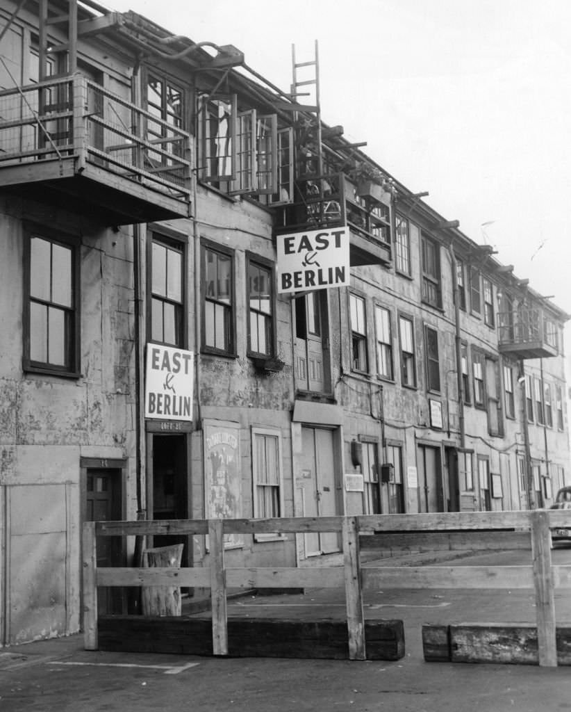 Signs hang on buildings in the T Wharf in Boston, Sept. 1, 1961.