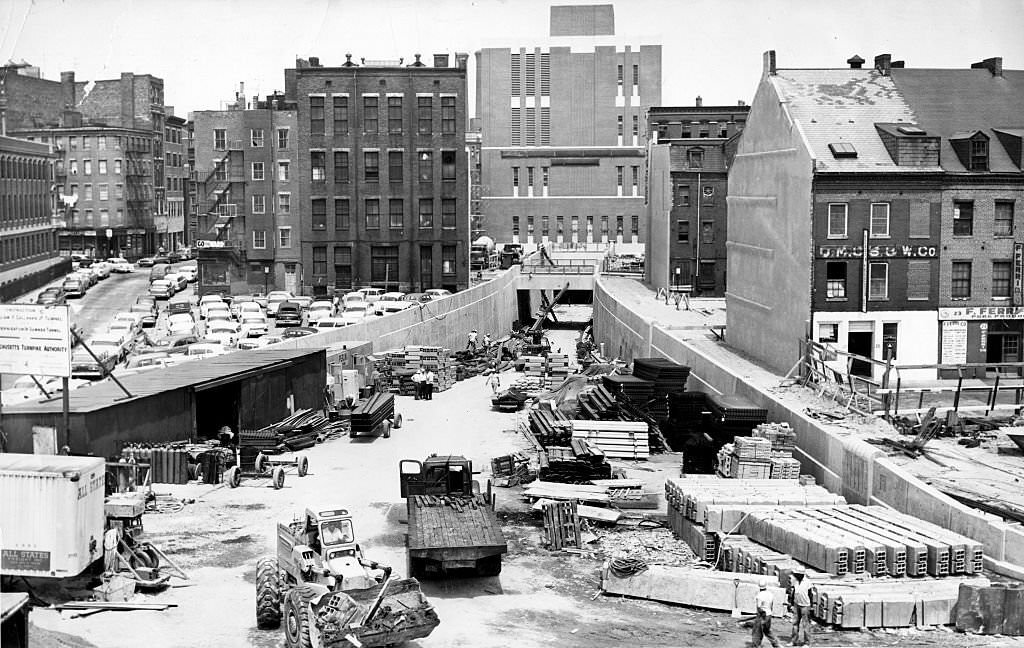 Men, machines, and material clutter the ramp leading to the new under-harbor crossing, the Callahan Tunnel, seen from Cross Street in Boston on July 13, 1961.
