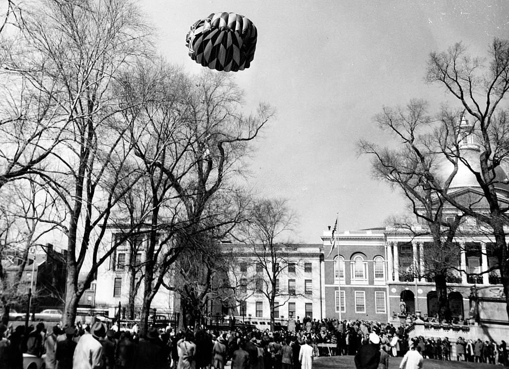 A parachutist floats down after jumping from an airplane over Boston Common on March 21, 1961.