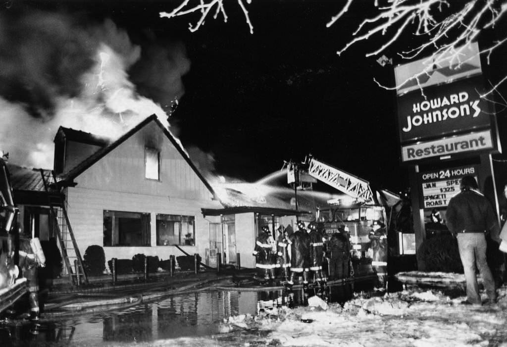 Firefighters battle a three-alarm fire at the Howard Johnson's hotel on Morrissey Boulevard in Boston, Jan. 25, 1961.