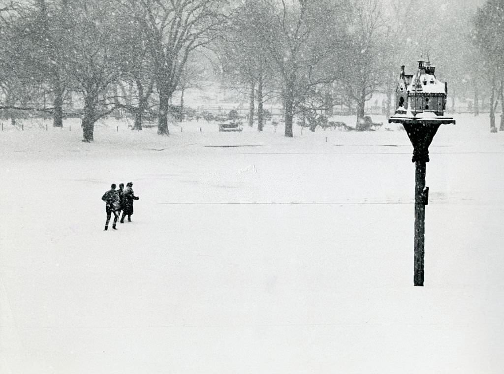 People walk over the frozen lagoon in the Public Garden in Boston, 1961.