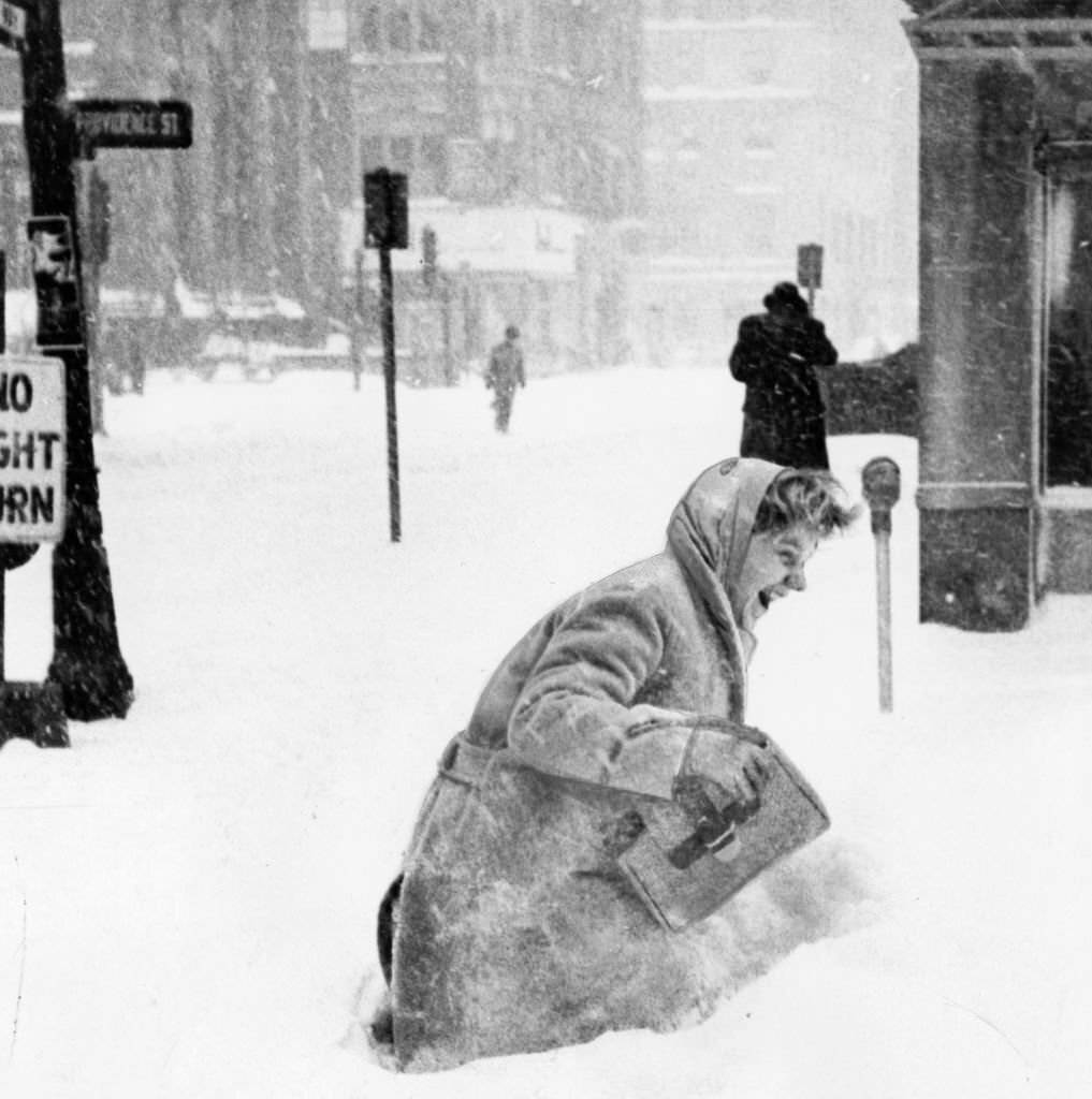 A girl wades through a snow drift in Park Square in Boston, 1960.