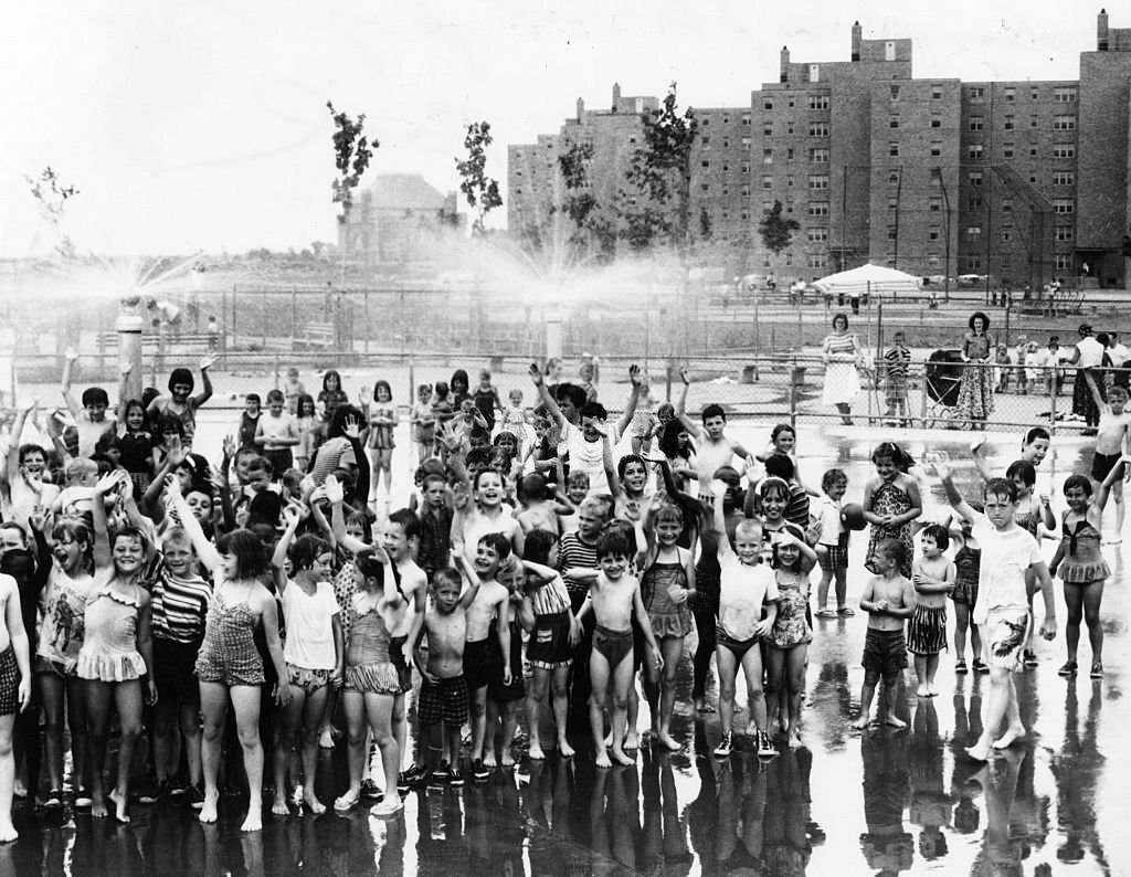 Children play in the spray pool at the Columbia Point housing project in Boston on June 30, 1960.