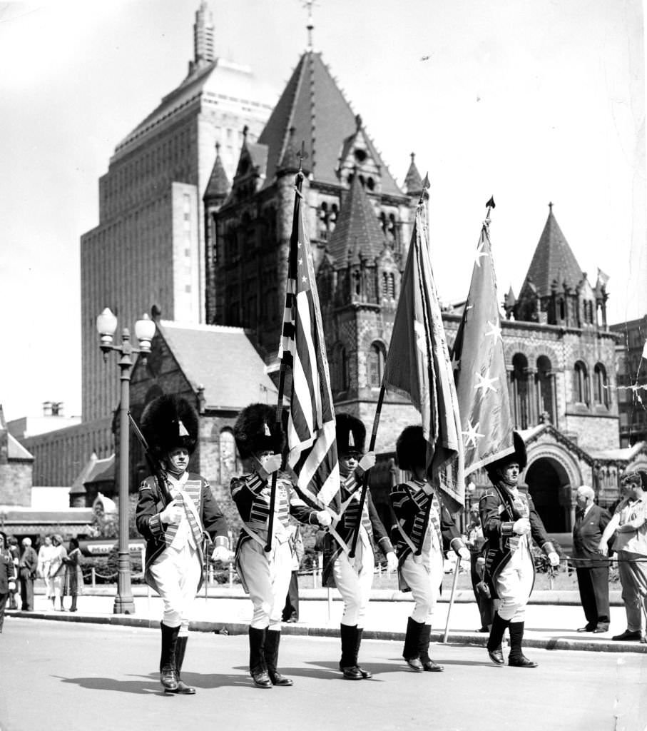 The color guard of the Ancient and Honorable Artillery Company of Boston parades on Boylston Street in front of Trinity Church in Copley Square in Boston on Jun. 6, 1960.