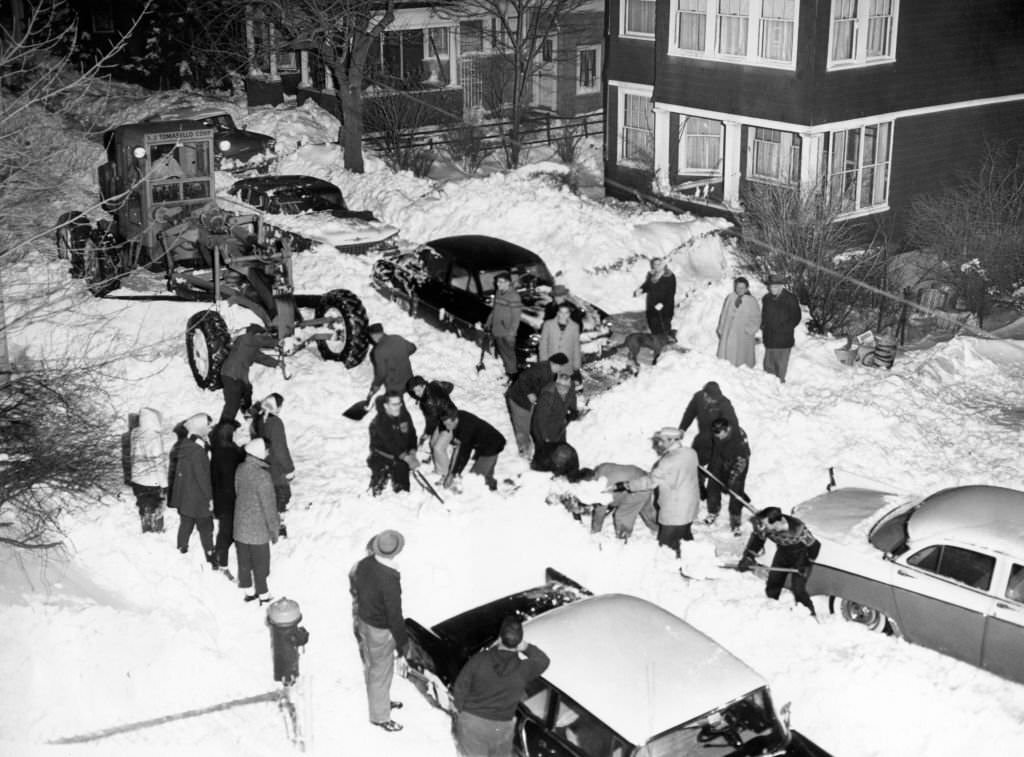 People shovel snow on Everett Street in Dorchester in Boston on March 5, 1960, after a snowstorm.
