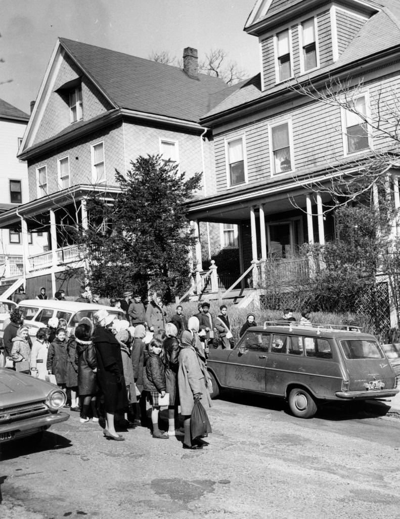 Schoolchildren from the Benedict Fenwick School pause to offer prayers outside the home of Reverend James J. Reeb.