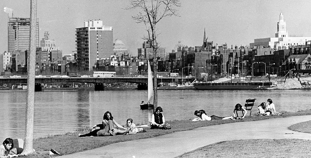 People sit along the Charles River on the Esplanade near Storrow Drive in Boston, 1965.