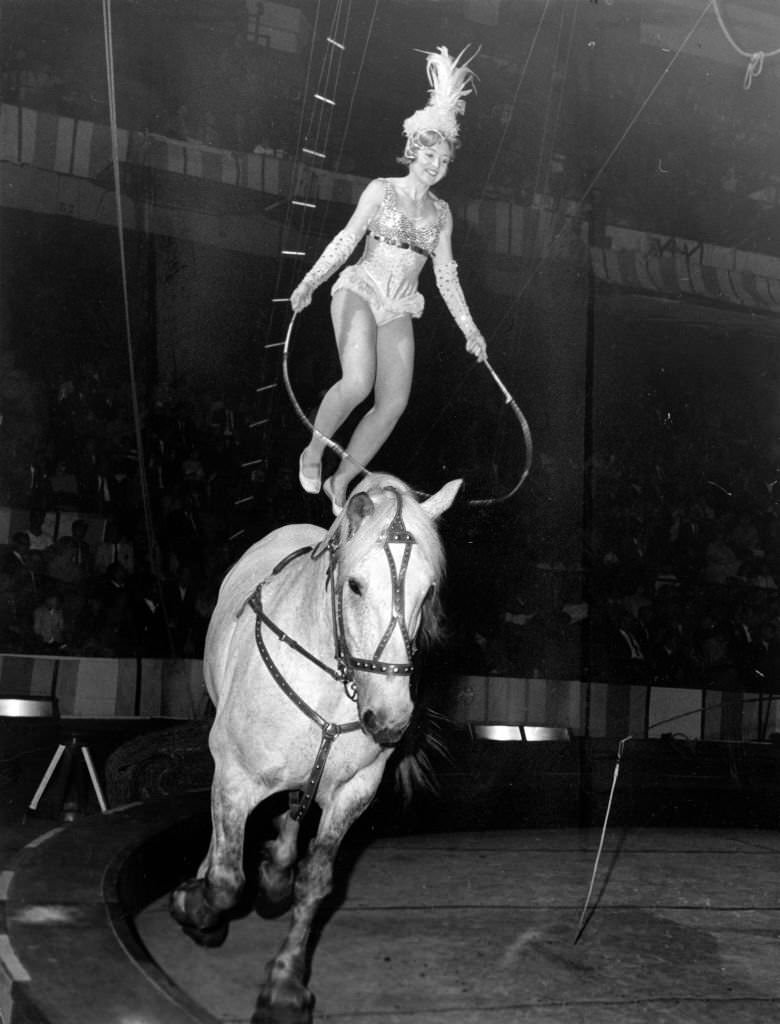 A performer jumps rope on a horse's back during the opening of the Ringling Bros. and Barnum & Bailey Circus at Boston Garden, May 15, 1965,