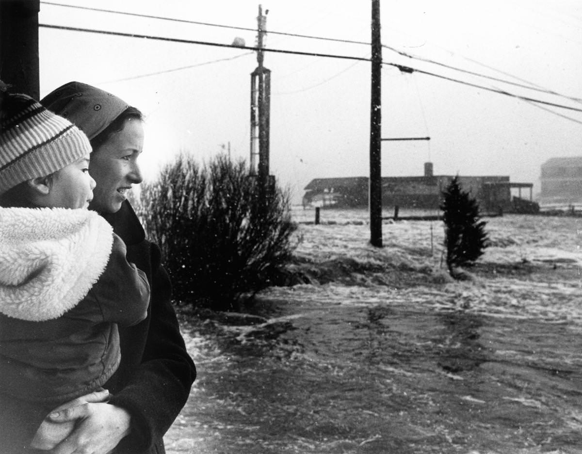 Kate Figueroa held her son Casey, 2, as they looked out at the extreme high tides and flooding in Plymouth on Feb. 7.