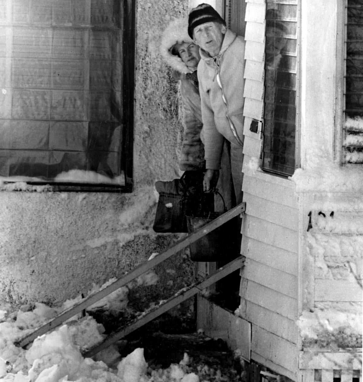 A man and woman wait for a rescue team in Revere on Feb. 8.