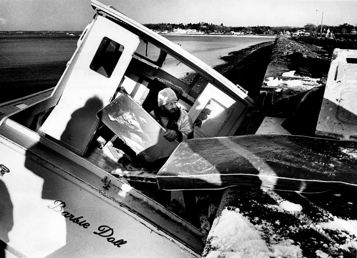 A crew member unloaded a lost boat in Marblehead Harbor that washed up on the Causeway.