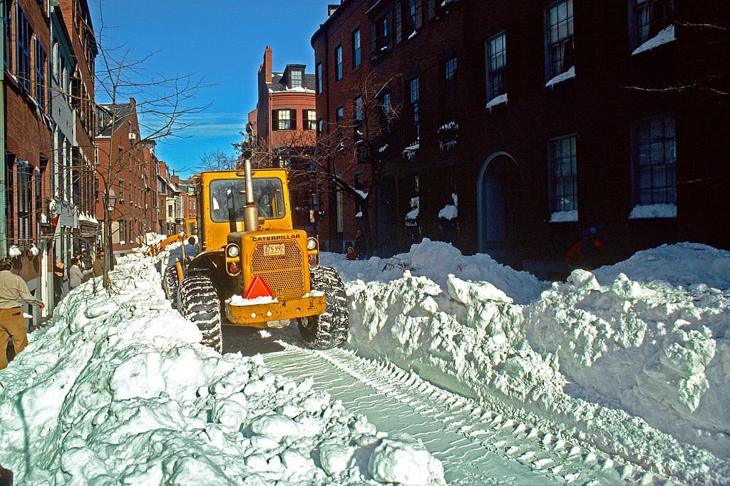 A Tractor Travels Down A Snowy Street