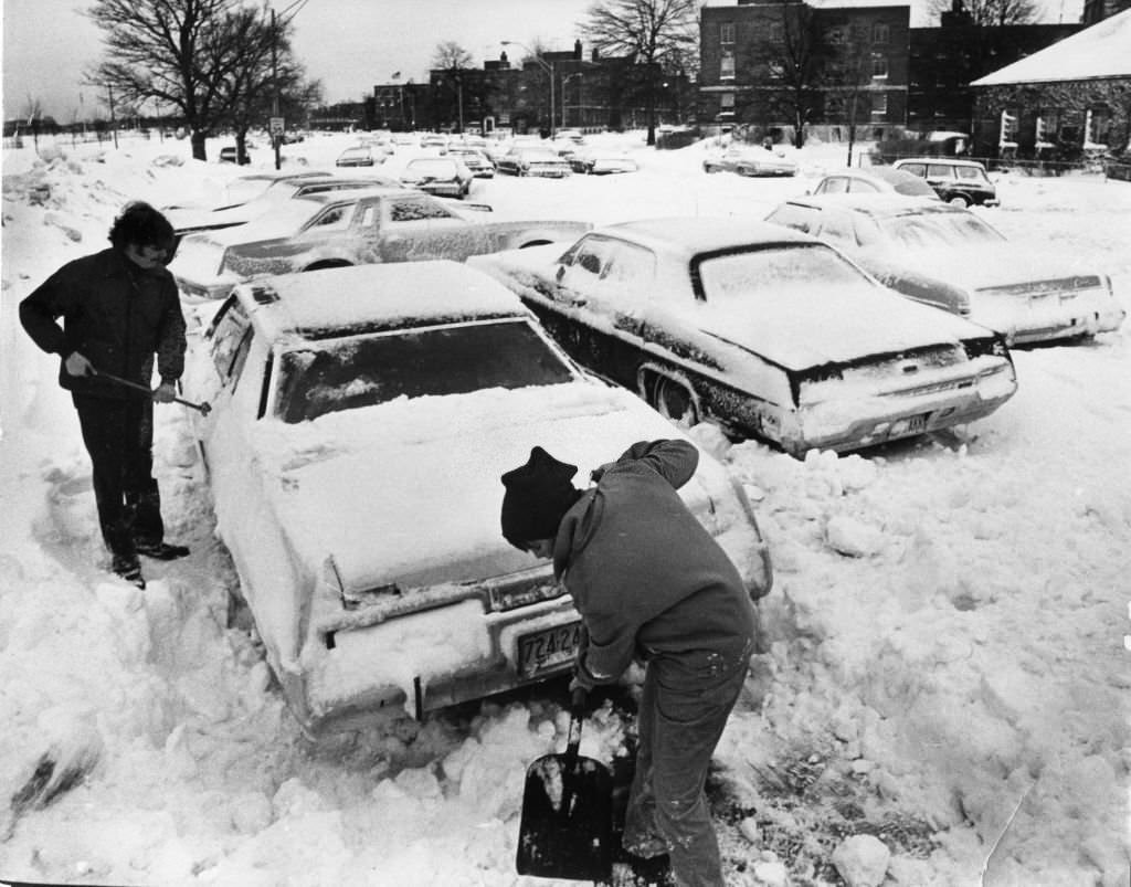 Two people dig out their car after a snowstorm in Boston, 1978.