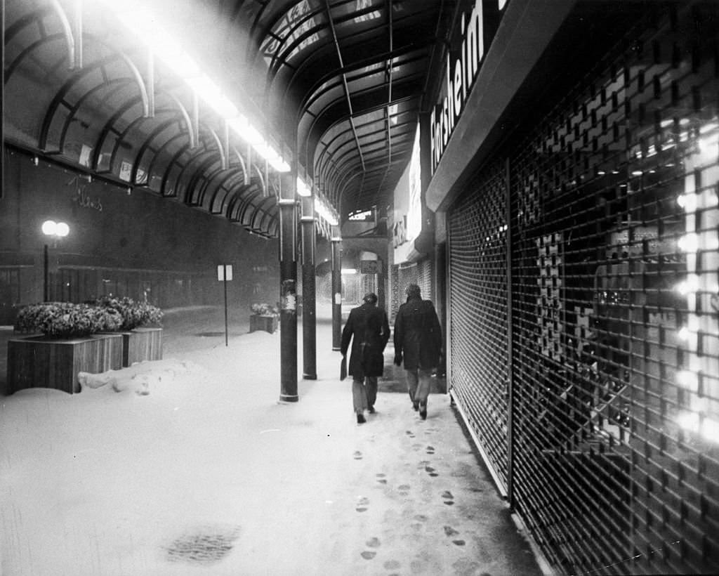 People walk down Washington Street near Bromfield Street in Boston on Feb. 6, 1978, during a record-breaking blizzard.