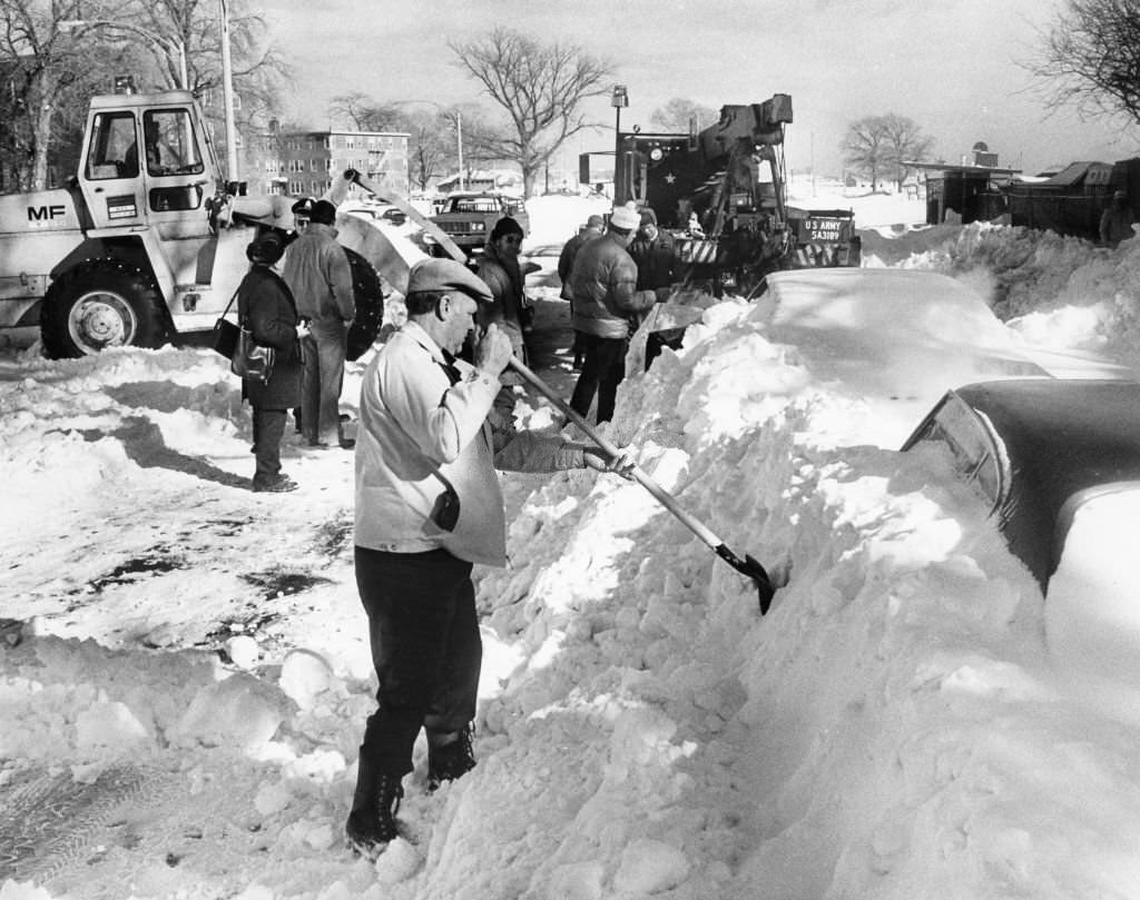 Car owners, MDC workers and the National Guard dig out cars buried in snow on Day Boulevard in South Boston after the "Blizzard of 78"