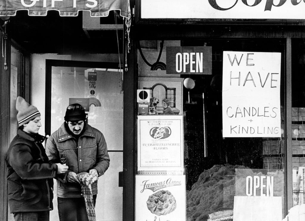 Two men stand outside a store on Boylston Street in Boston that is advertising wood on Feb. 8, 1978.