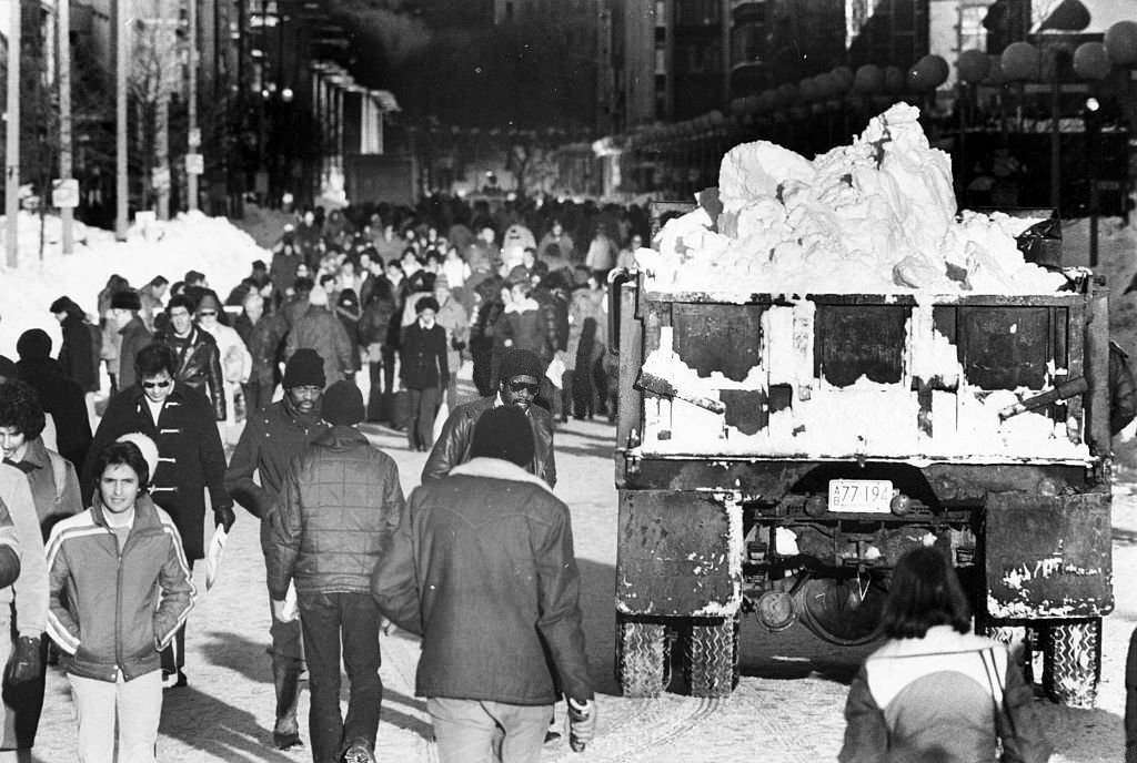 A truck filled with snow passes pedestrians on Boylston Street in Boston at 2 p.m. on Feb. 10, 1978, following the "Blizzard of 78".