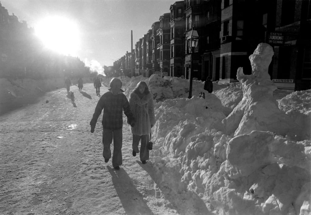 Pedestrians take a sunset stroll along a snow-covered Newbury Street in Boston following the "Blizzard of 78".