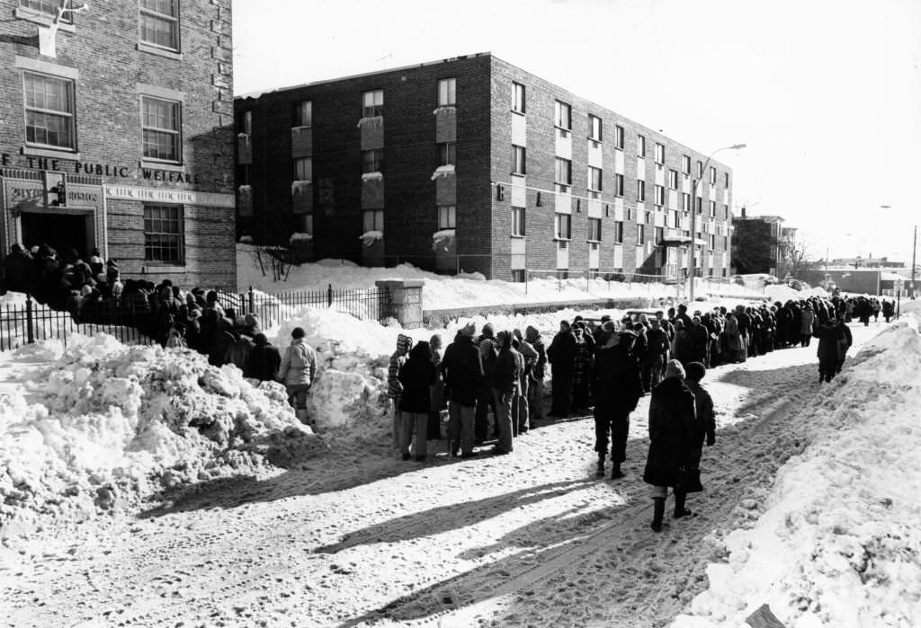 Thousands of people wait for vouchers in the snow on Hancock Street in the Dorchester neighborhood of Boston on Feb. 11, 1978.