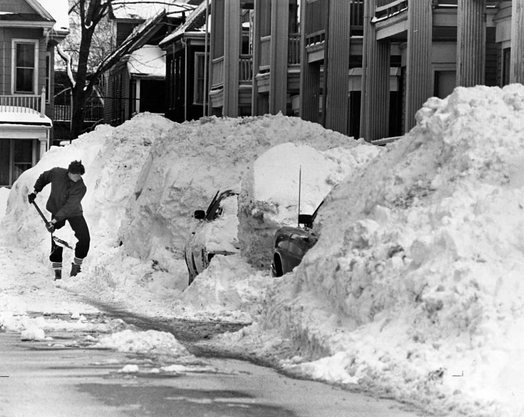A would-be motorist has his work cut out for him on Hallam Street in Dorchester on March 4, 1978.