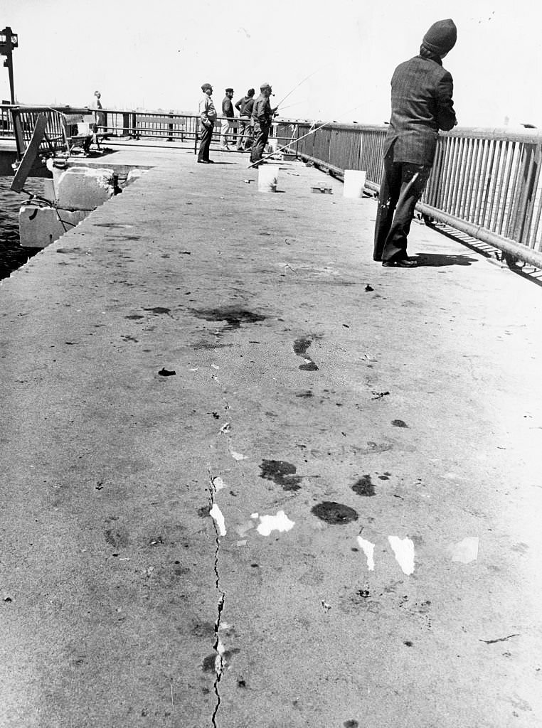 Men fish on Boston's Castle Island pier on April 26, 1978.