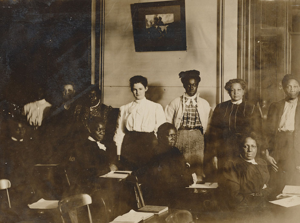 A group of 10 women in a classroom